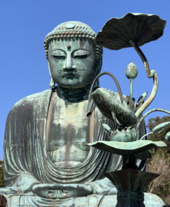 Buddha with blue sky and sculpted flowers