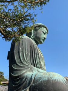 Buddha, blue sky and trees