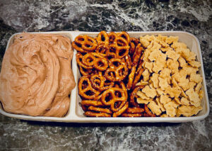 chocolate dip, pretzels, graham crackers in a dish